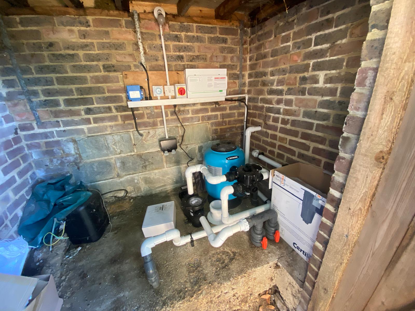 Compact brick pool plant room with filter and connected plumbing