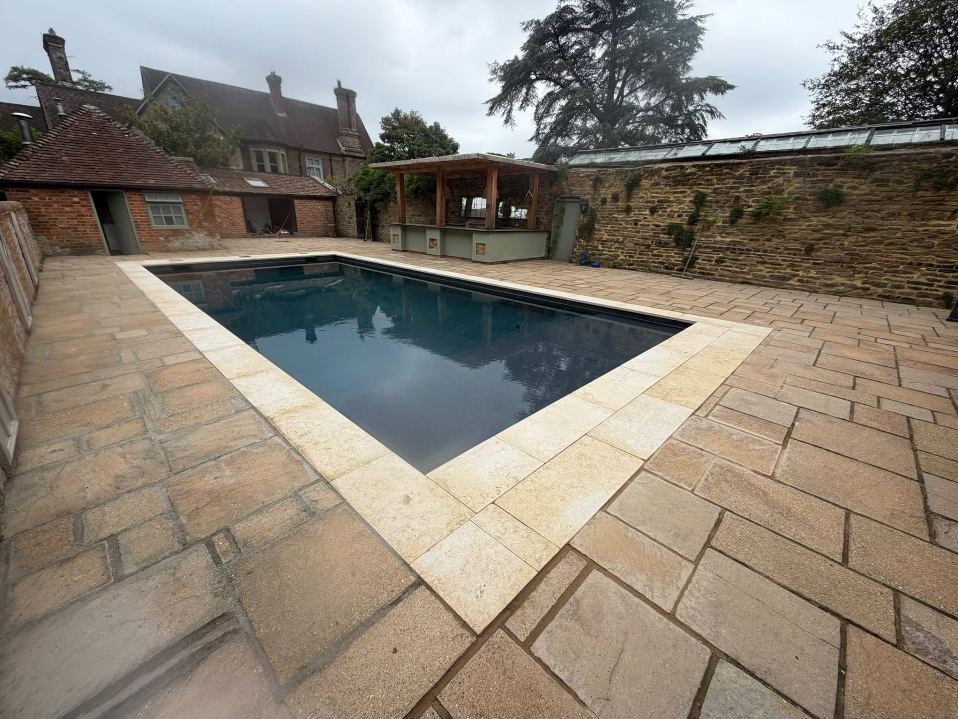 Courtyard swimming pool surrounded by stone paving