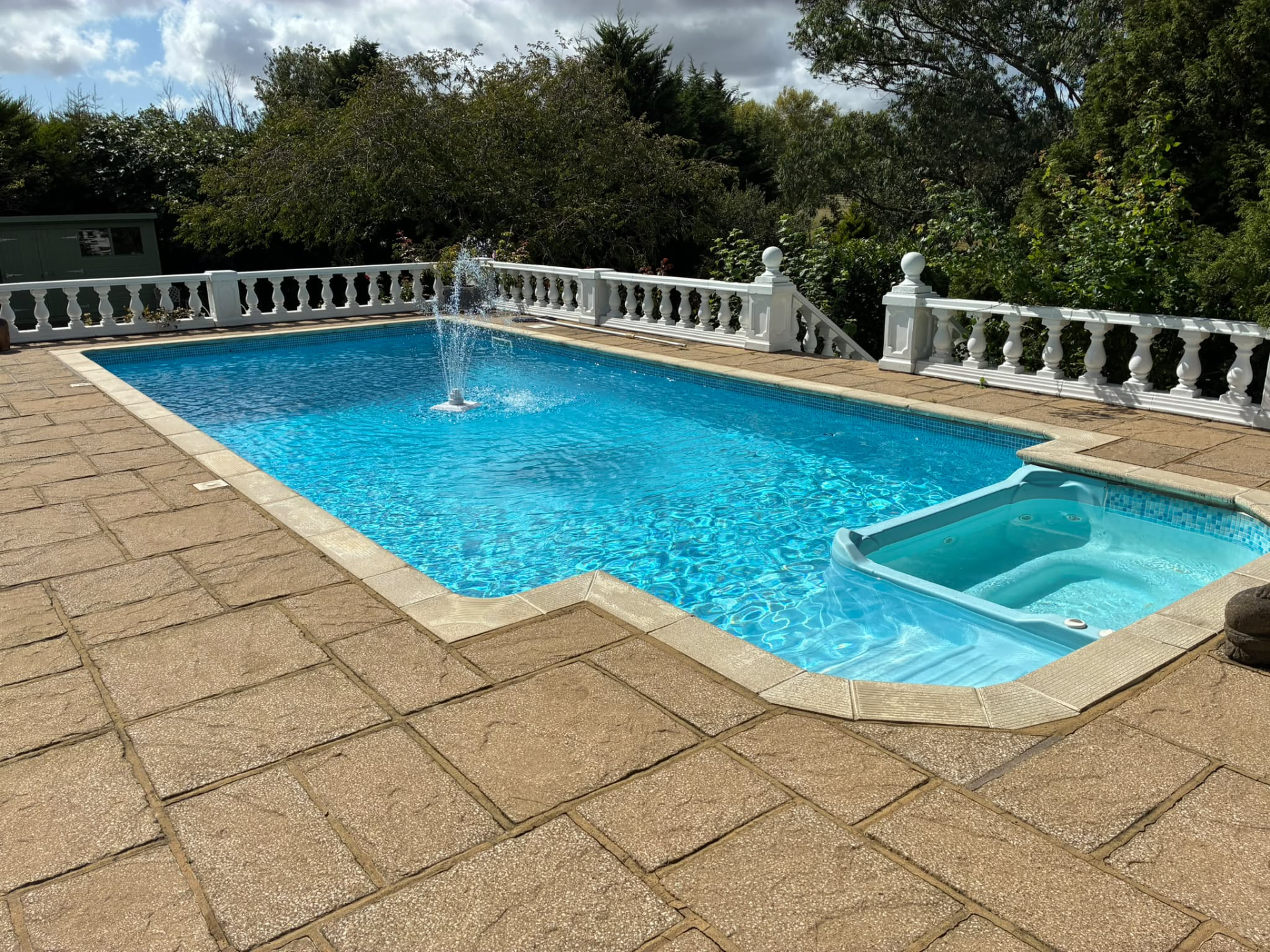 Swimming pool with fountain and built-in spa