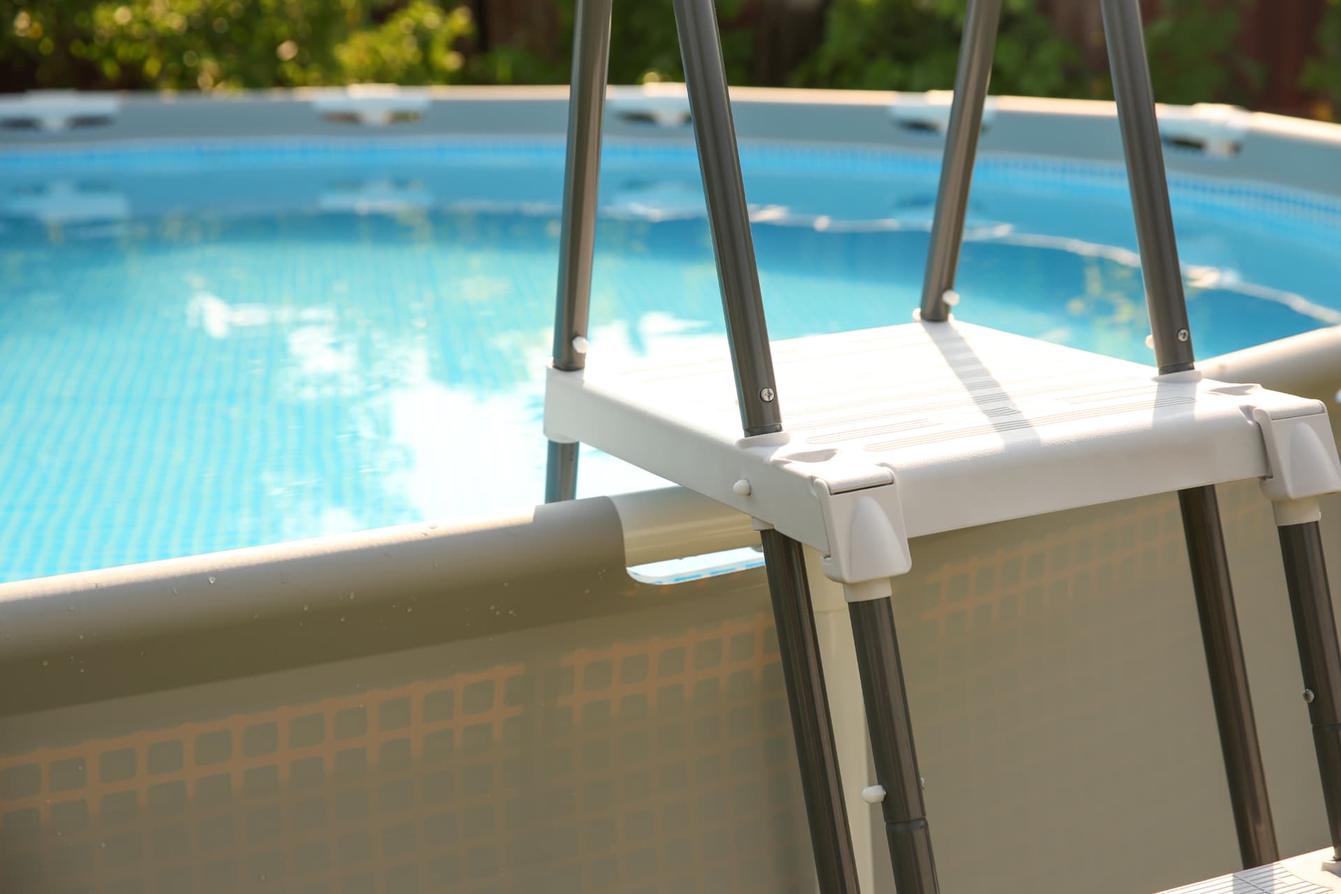 Above-ground pool with ladder and clear blue water