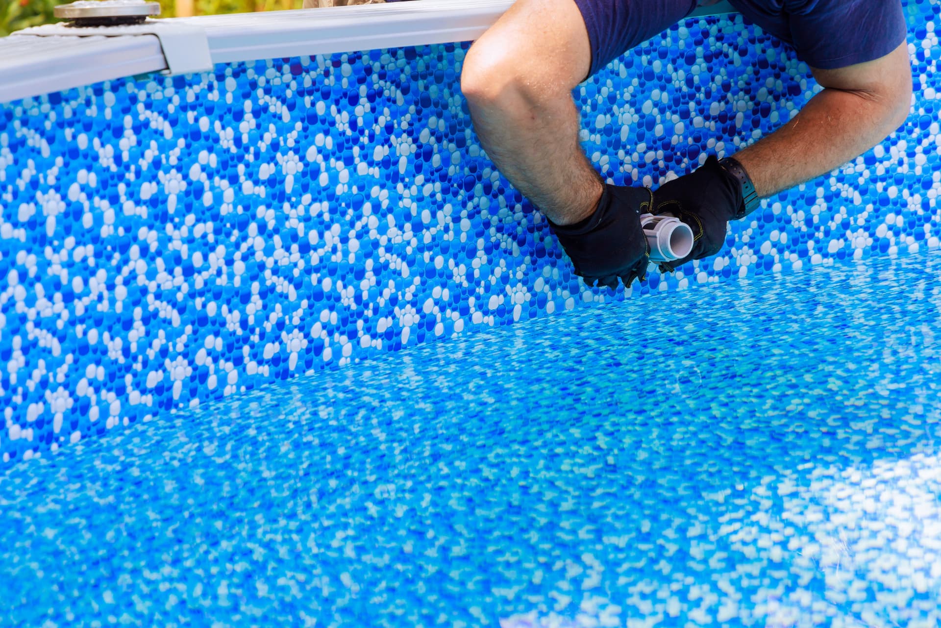 Engineer fitting a fitting through a new patterned pool liner