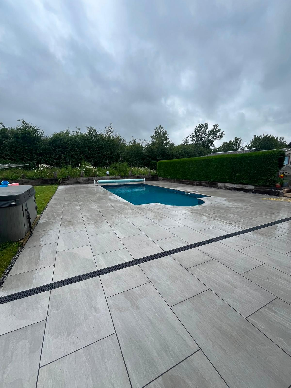 After: Pool patio relaid with new porcelain paving